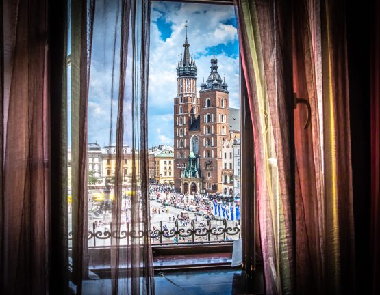 Cracow (Krakow) - Main Square (Rynek Glowny) with Marketplace (Sukiennice), Adam Mickiewicz Monument (pomnik Adama Mickiewicza), church of Saint Mary (Kosciol Mariacki) and church of Saint Adalbert (Kosciol sw. Wojciecha) - window view